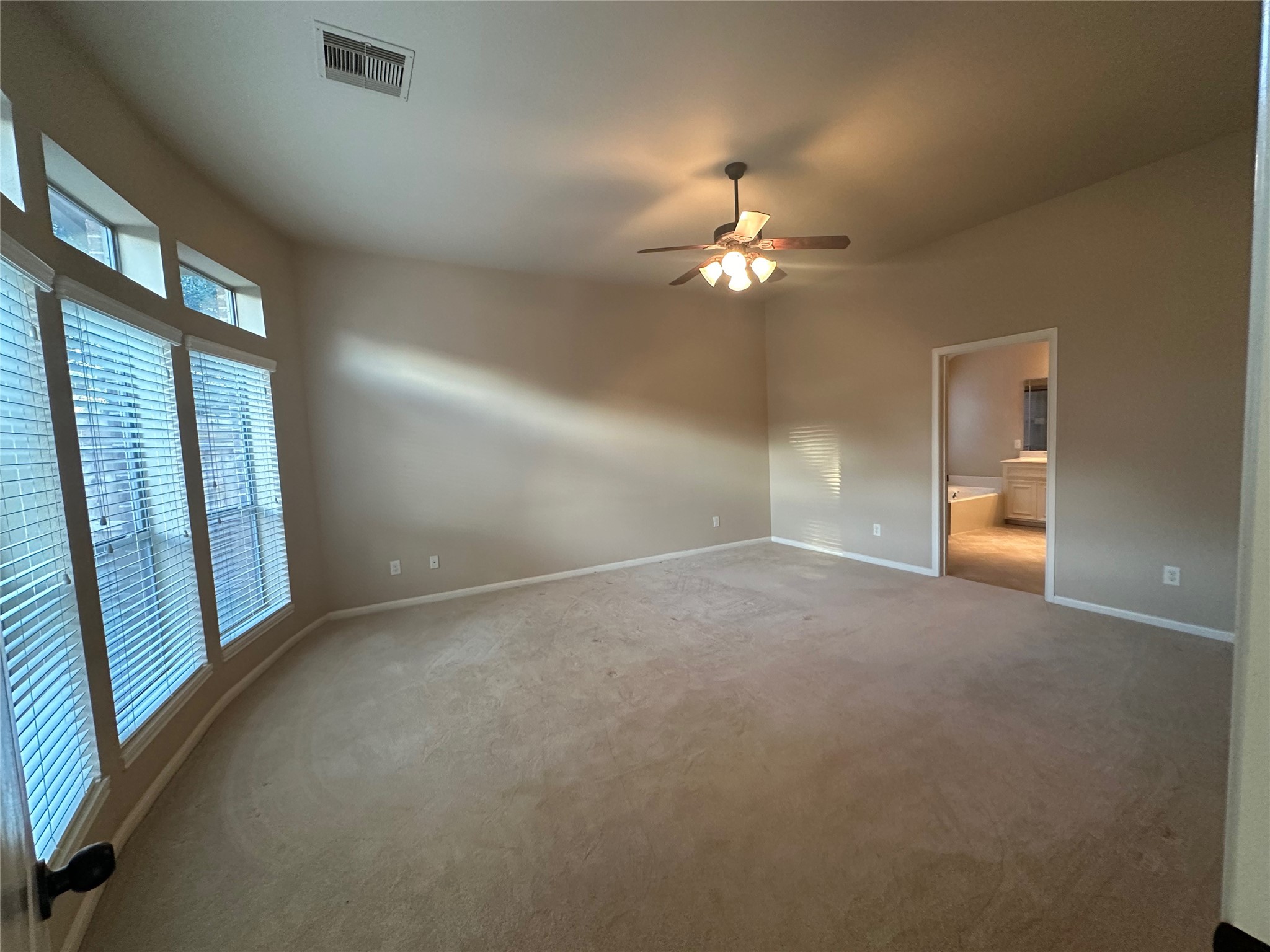 2922 Firewalk Trace Katy, TX 77494 - Photo 22 of 38 en empty room with windows and chandelier fan