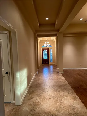 a view of a hallway with wooden shelves