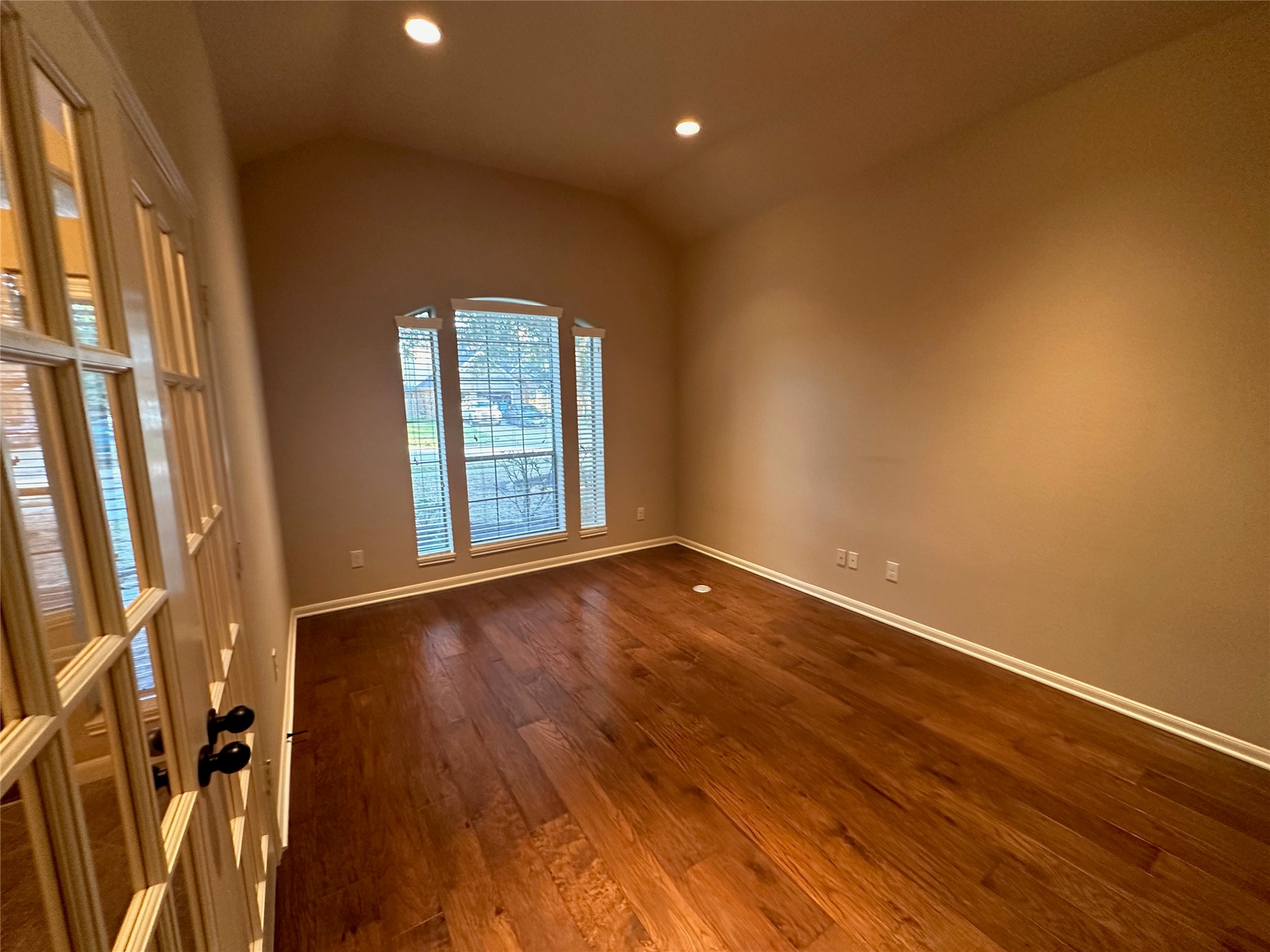 2922 Firewalk Trace Katy, TX 77494 - Photo 7 of 38 a view of an empty room with a window and wooden floor
