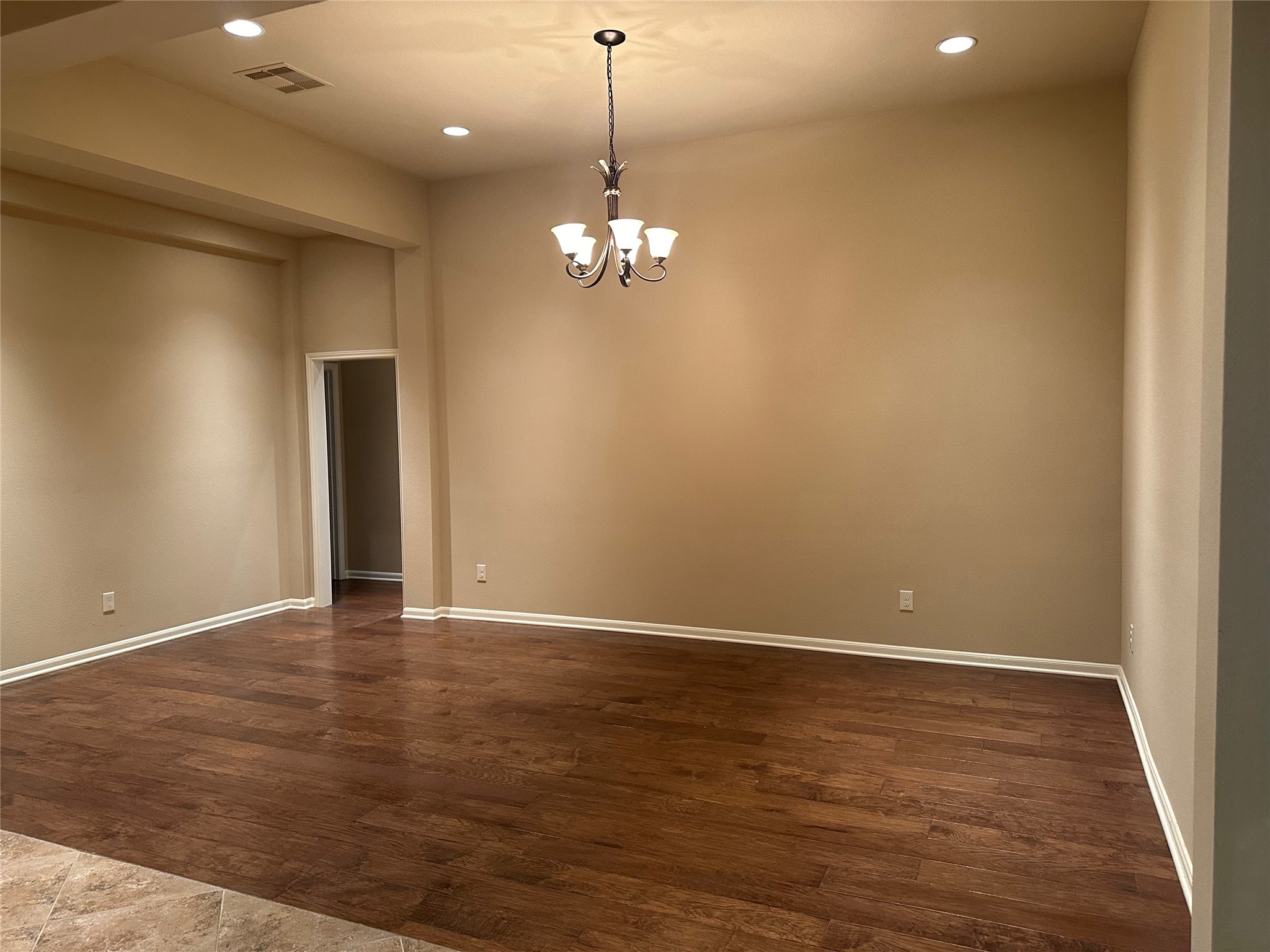 2922 Firewalk Trace Katy, TX 77494 - Photo 9 of 38 a view of an empty room with chandelier fan and wooden floor