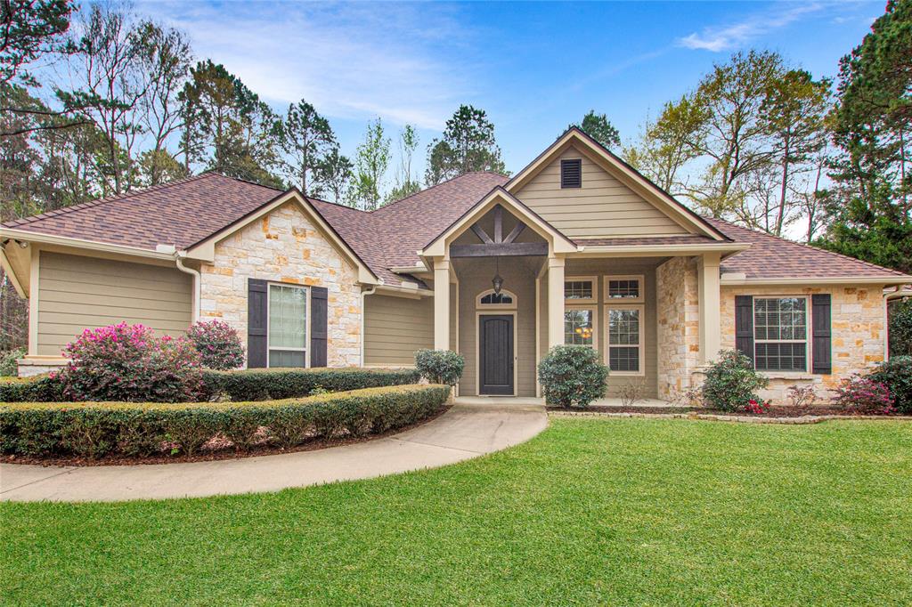 a front view of a house with a garden and plants