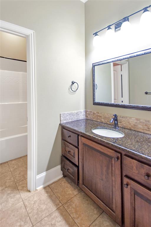 15207 Maple Leaf Court Tyler, TX 75707 - Photo 13 of 29 a bathroom with a granite countertop sink and a mirror