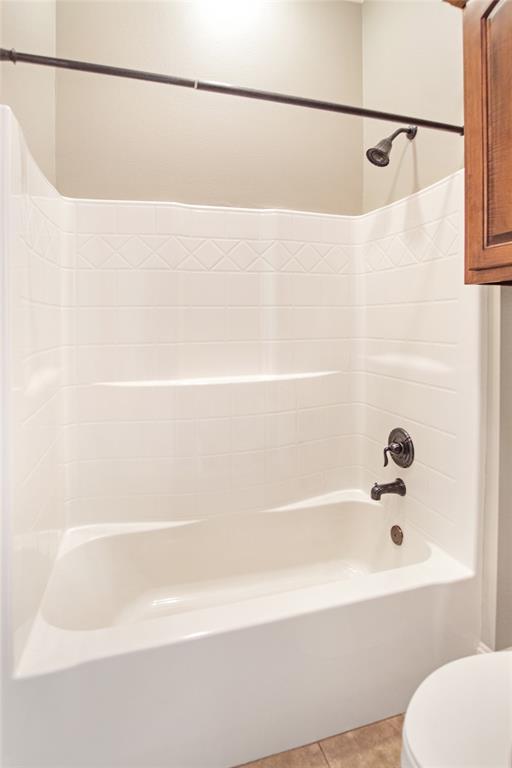 15207 Maple Leaf Court Tyler, TX 75707 - Photo 14 of 29 a bathroom with a bathtub and a shower