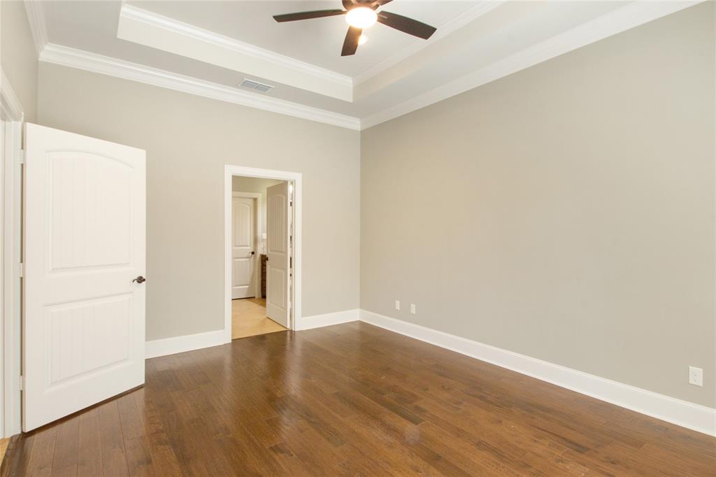 15207 Maple Leaf Court Tyler, TX 75707 - Photo 19 of 29 an empty room with wooden floor chandelier fan and windows