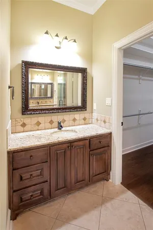 a spacious bathroom with a tub sink and mirror