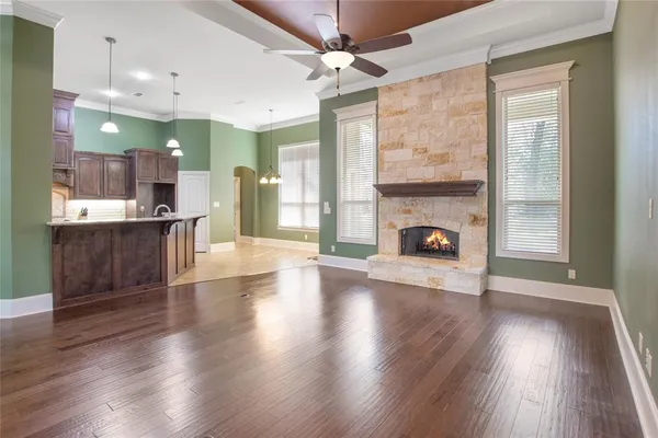 a view of a livingroom with a fireplace and wooden floor