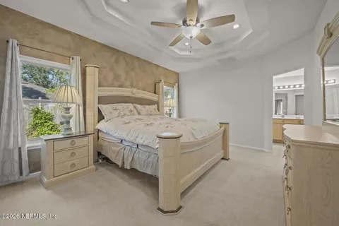 a bed room with a bed and a chandelier