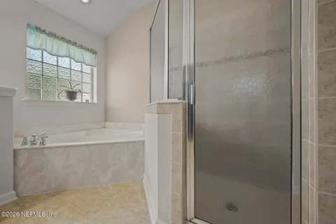 a bathroom with a bathtub and shower