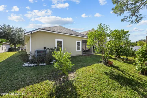 a front view of house with a garden