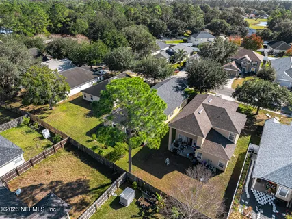 an aerial view of a house with a yard