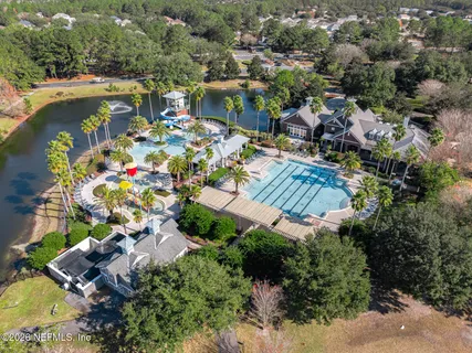 an aerial view of residential houses with outdoor space and swimming pool