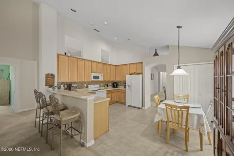 a kitchen with cabinets and refrigerator