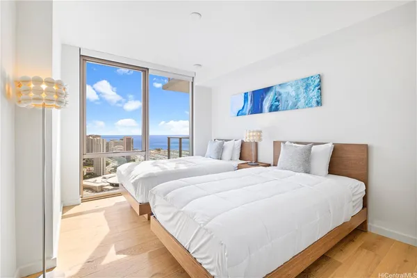 a bedroom with a bed and a large window