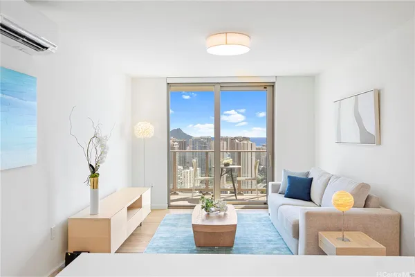 a living room with furniture and a potted plant