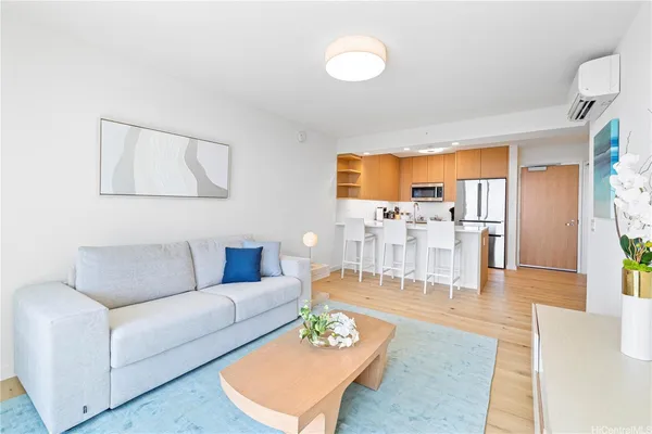 a living room with furniture wooden floor and a large window