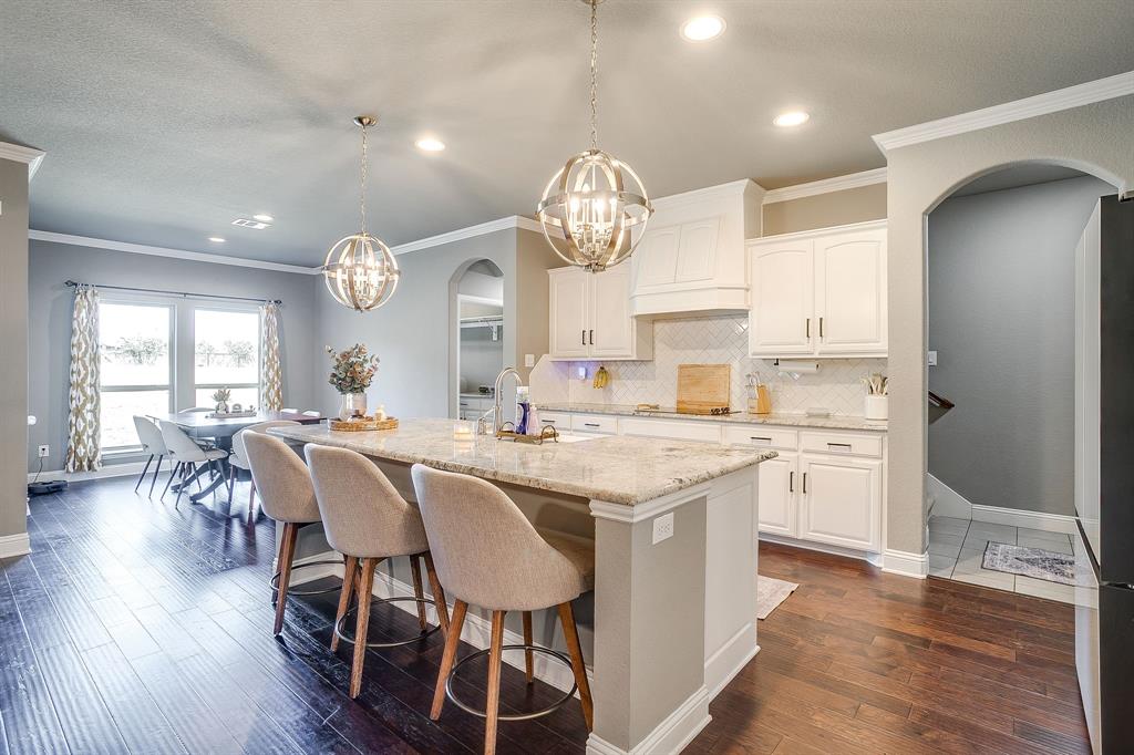 112 Lone Star Way Godley, TX 76044 - Photo 11 of 40 a large kitchen with a table and chairs