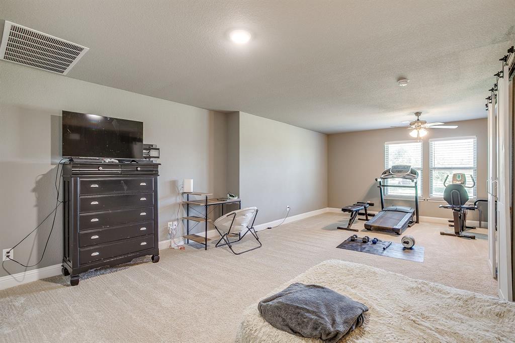 112 Lone Star Way Godley, TX 76044 - Photo 14 of 40 a view of a livingroom with furniture and a flat screen tv
