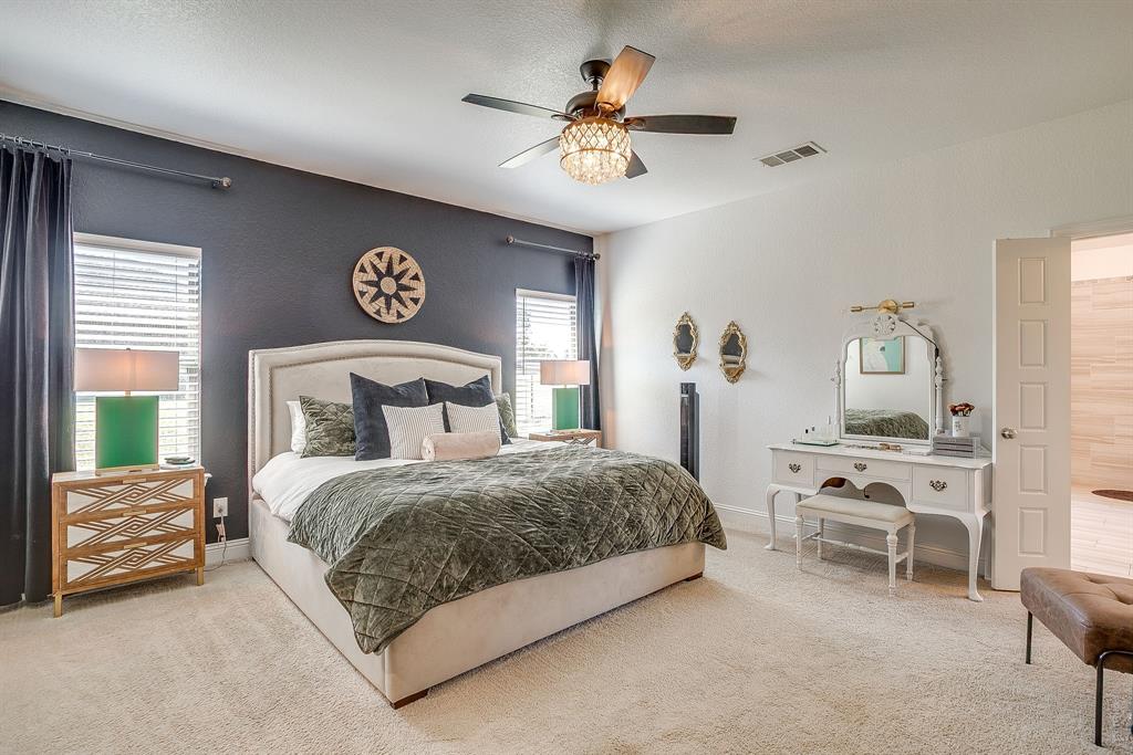 112 Lone Star Way Godley, TX 76044 - Photo 17 of 40 a bedroom with a bed and a chandelier