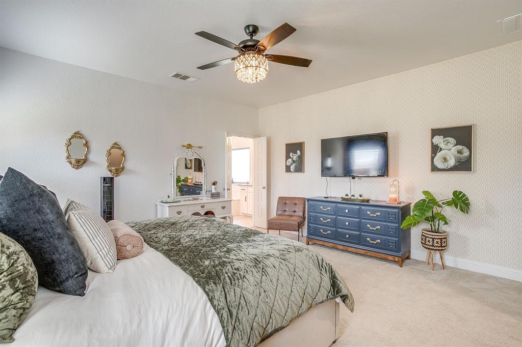 112 Lone Star Way Godley, TX 76044 - Photo 18 of 40 a bedroom with a bed and a dresser