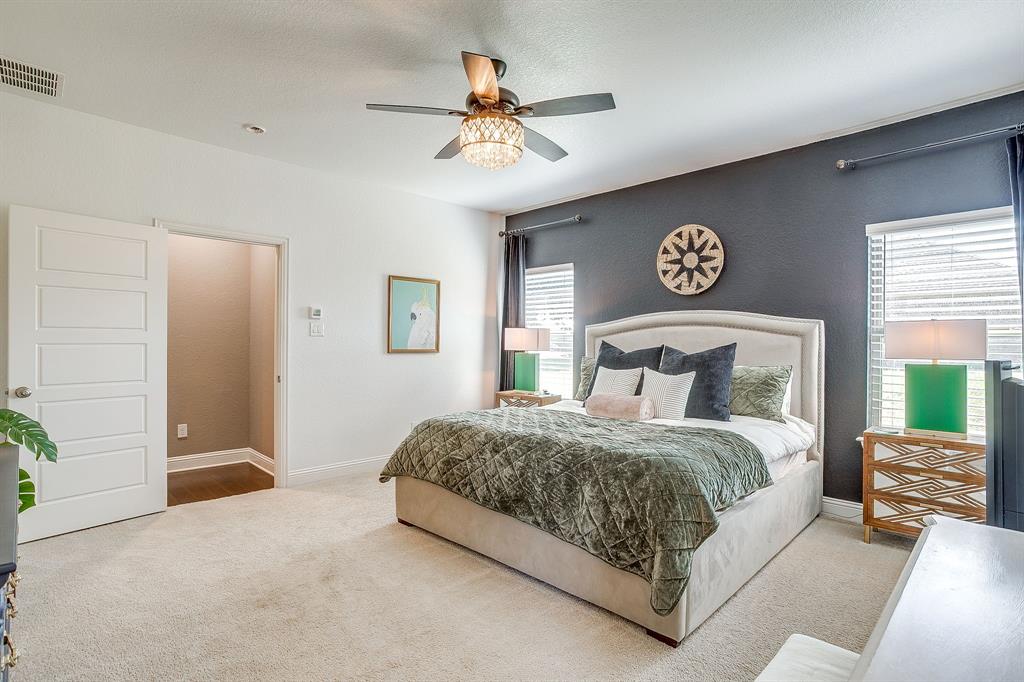112 Lone Star Way Godley, TX 76044 - Photo 20 of 40 a bedroom with a bed and a chandelier