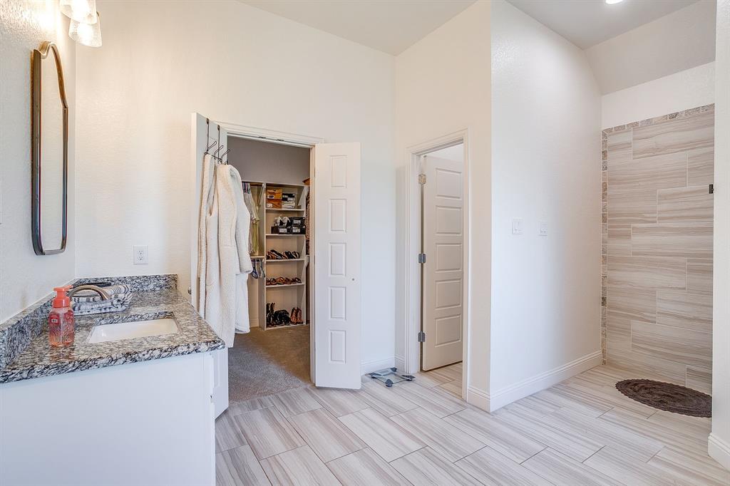 112 Lone Star Way Godley, TX 76044 - Photo 22 of 40 a bathroom with a granite countertop sink and a mirror