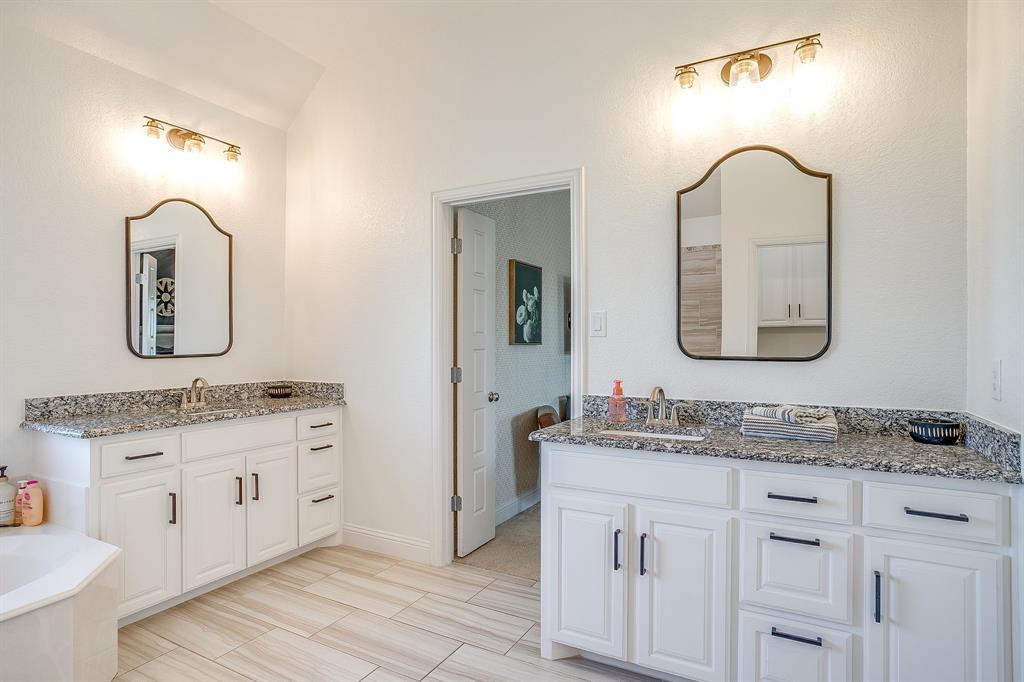 112 Lone Star Way Godley, TX 76044 - Photo 24 of 40 a bathroom with a double vanity sink and a mirror