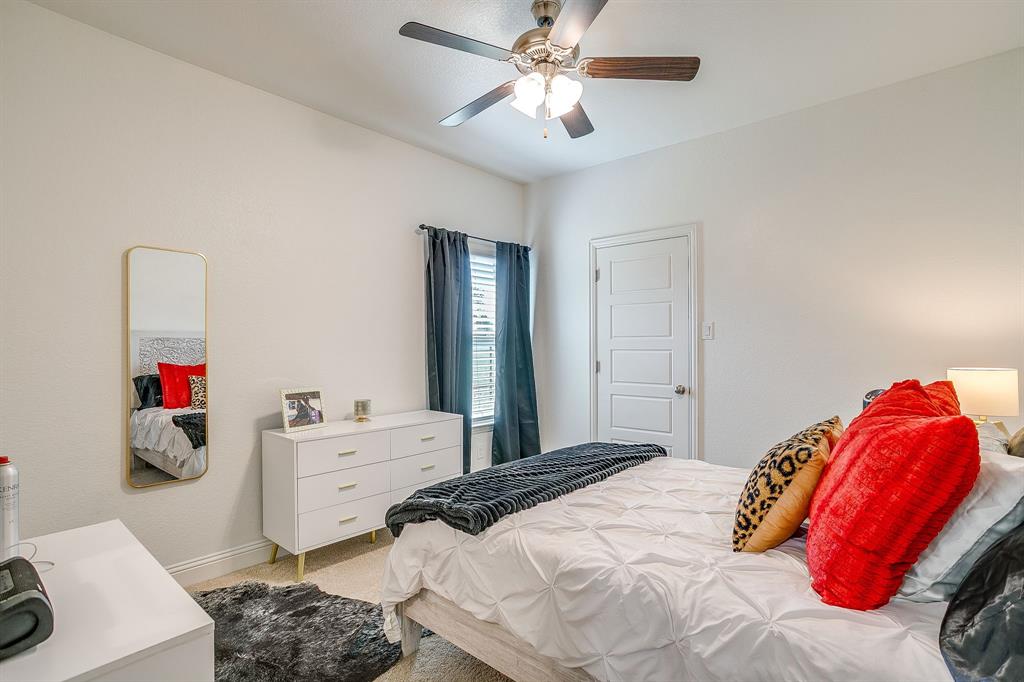 112 Lone Star Way Godley, TX 76044 - Photo 26 of 40 a bedroom with a bed and a chandelier