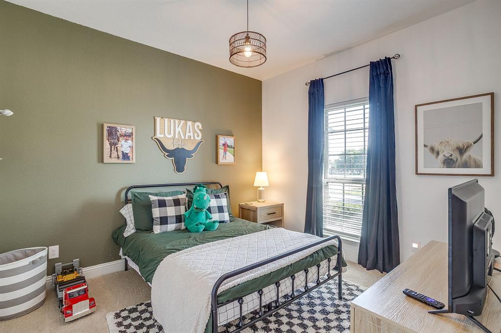 112 Lone Star Way Godley, TX 76044 - Photo 28 of 40 a bedroom with a bed and wooden floor