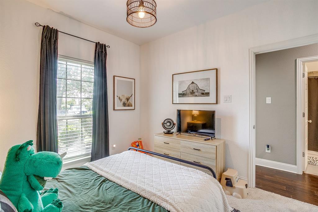 112 Lone Star Way Godley, TX 76044 - Photo 29 of 40 a bedroom with a bed and wooden floor