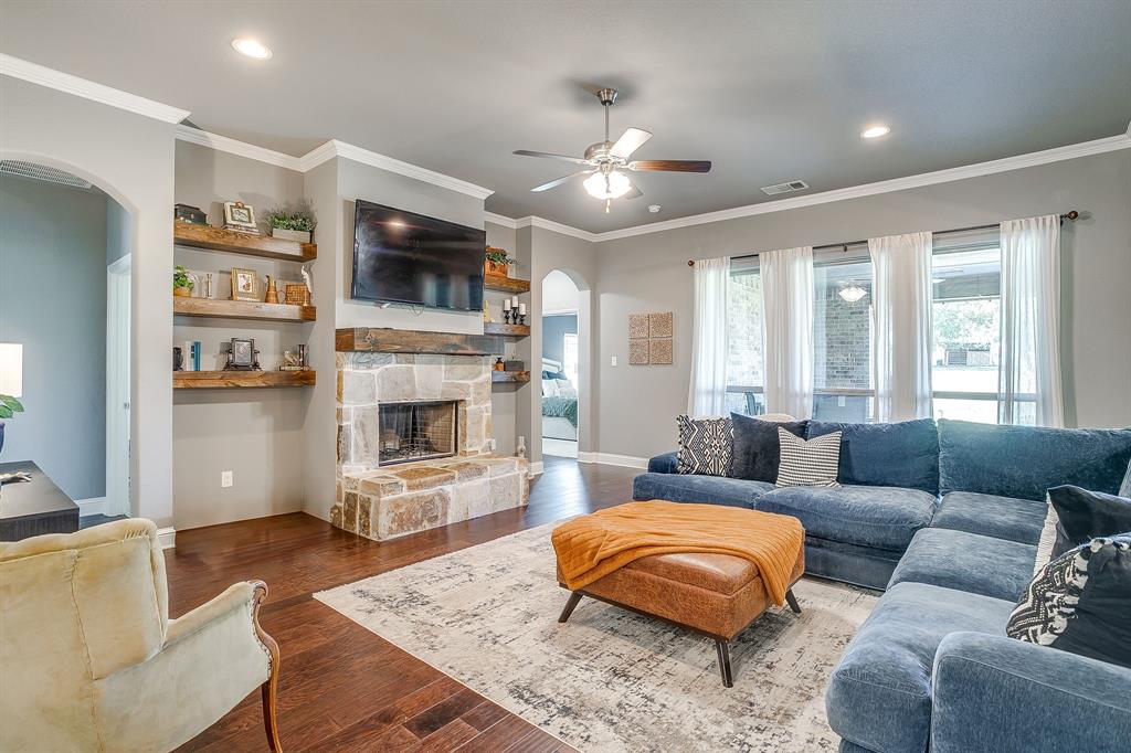 112 Lone Star Way Godley, TX 76044 - Photo 4 of 40 a living room with furniture a flat screen tv and a fireplace