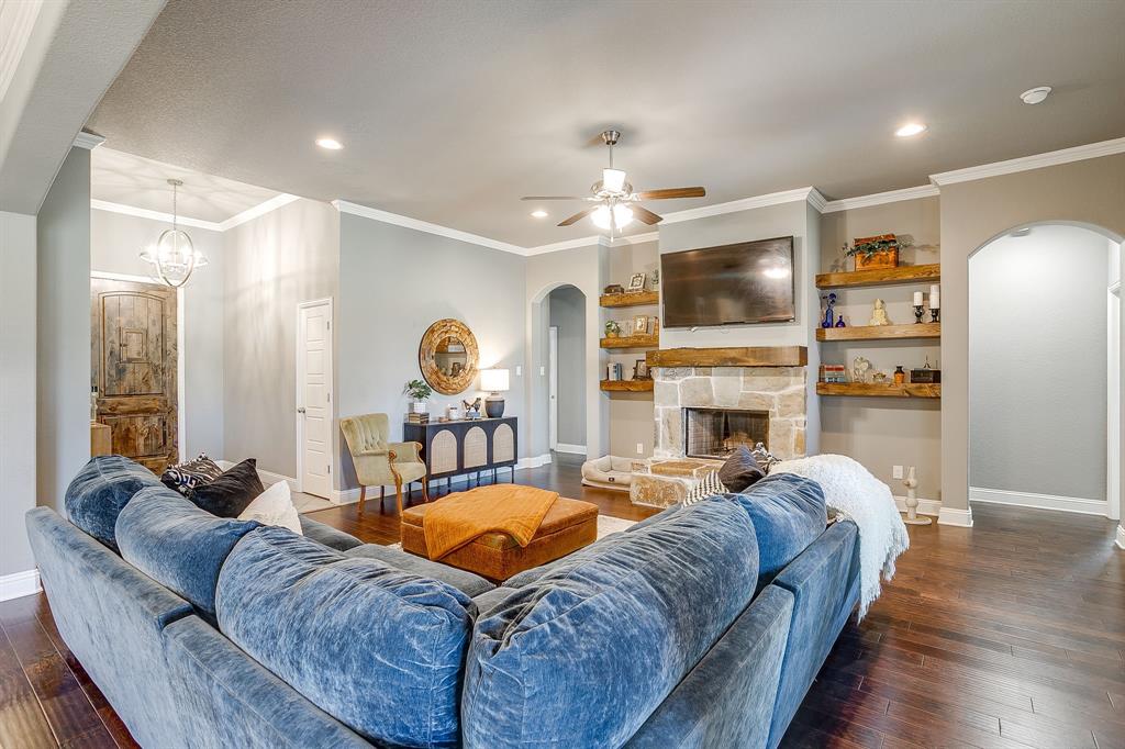 112 Lone Star Way Godley, TX 76044 - Photo 5 of 40 a living room with furniture a fireplace and a flat screen tv