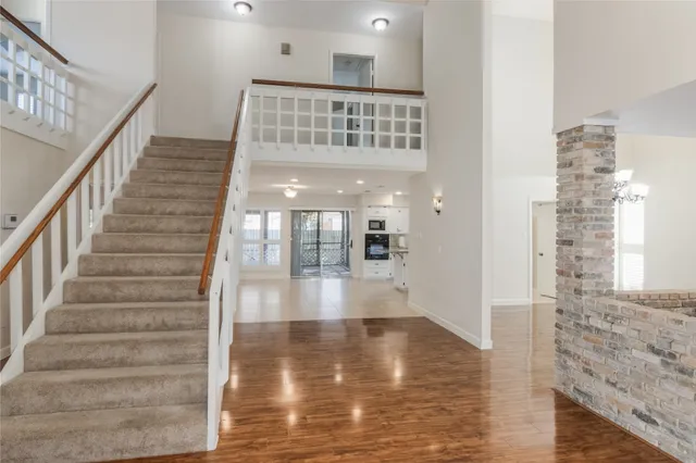 a large kitchen with stainless steel appliances kitchen island granite countertop a large stove top oven and cabinets