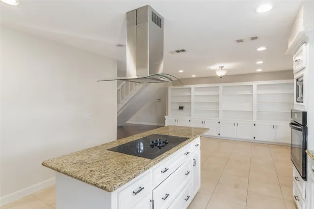 a kitchen with granite countertop cabinets stainless steel appliances and a sink