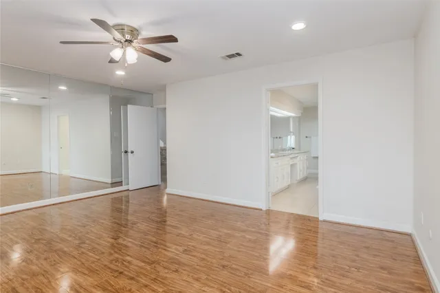 a spacious bathroom with a granite countertop sink a mirror and a shower