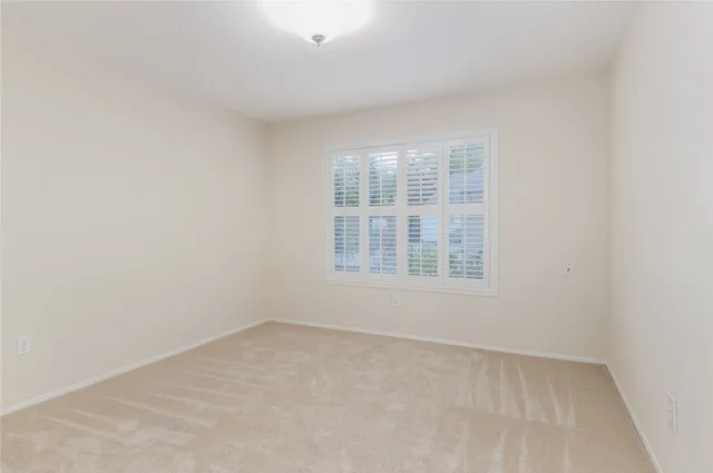a bathroom with a granite countertop sink a toilet and a mirror