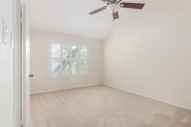 a view of a livingroom with a ceiling fan and window