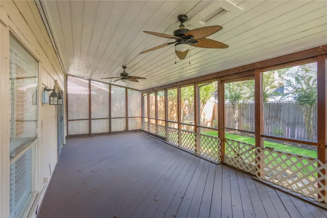 a view of a livingroom with a ceiling fan and window