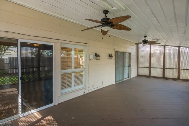 a view of a house with a small yard and wooden fence