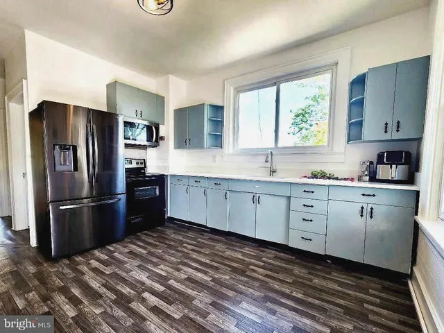 a kitchen with a sink stove and refrigerator