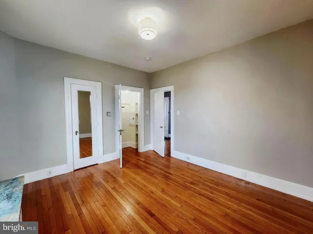 a view of a hallway to a livingroom with furniture and stairs