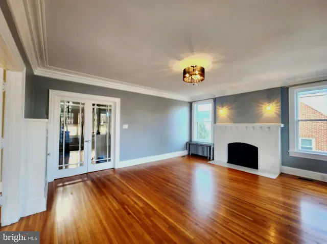 a view of an empty room with a fireplace and a window