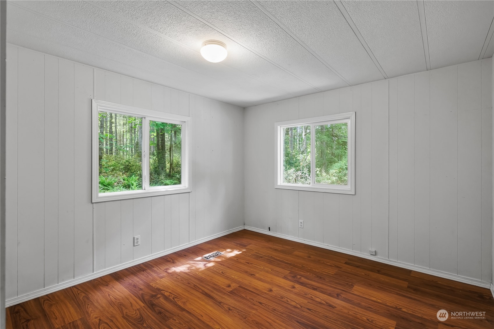 7342 Steamboat Island Road Northwest Olympia, WA 98502 - Photo 23 of 40 an empty room with wooden floor and windows
