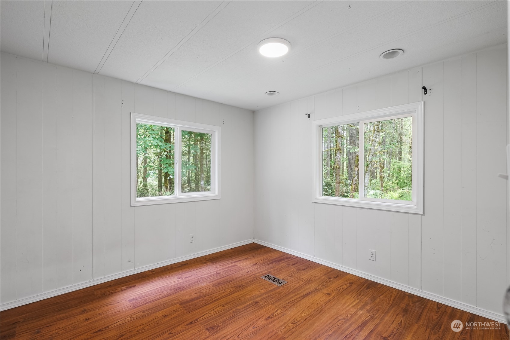 7342 Steamboat Island Road Northwest Olympia, WA 98502 - Photo 24 of 40 a view of an empty room with wooden floor and a window