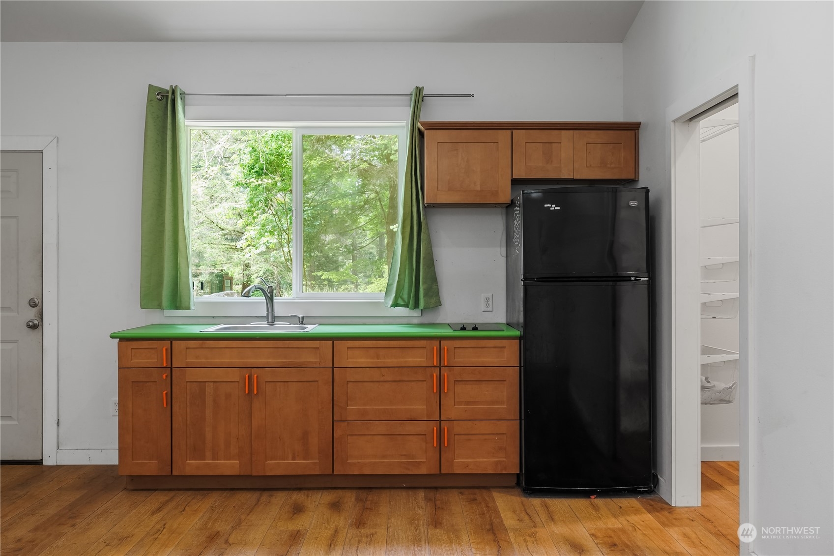 7342 Steamboat Island Road Northwest Olympia, WA 98502 - Photo 29 of 40 a kitchen with a refrigerator and window