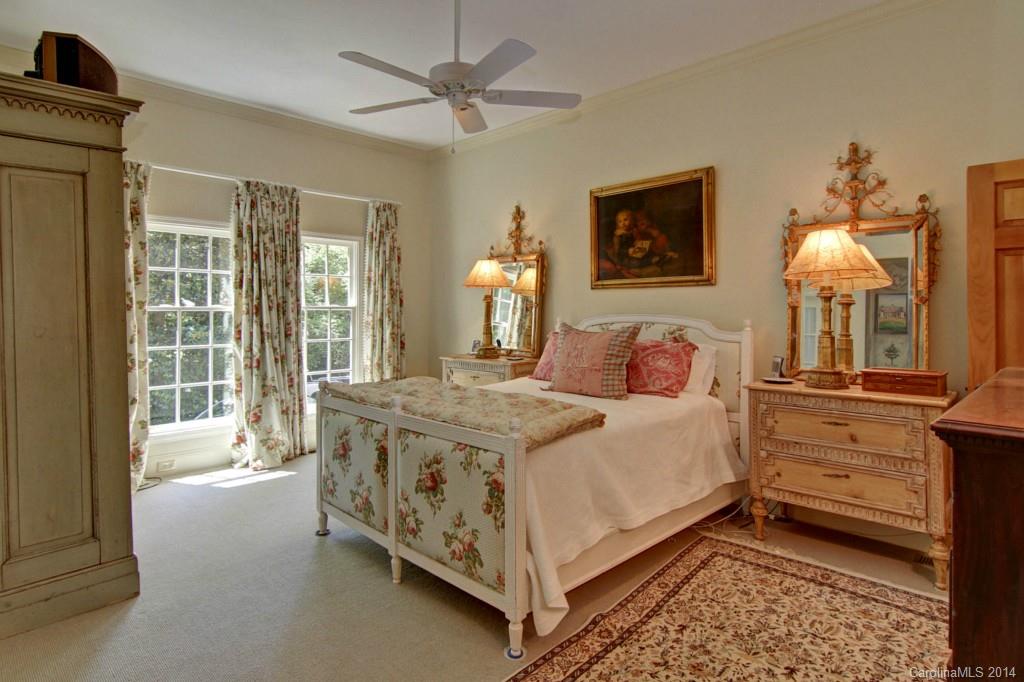 3044 High Ridge Road Charlotte, NC 28270 - Photo 14 of 24 a bedroom with a bed and a chandelier