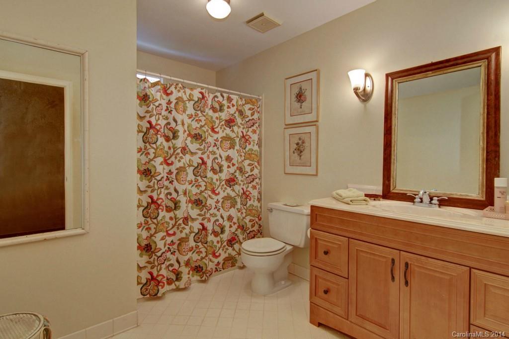3044 High Ridge Road Charlotte, NC 28270 - Photo 22 of 24 a bathroom with a granite countertop toilet a sink a mirror a shower and a double vanity