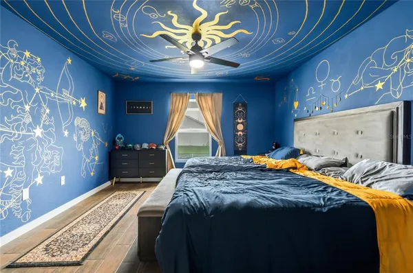 a bedroom with a bed and a chandelier