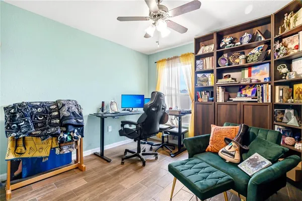 a living room with furniture a rug and a book shelf