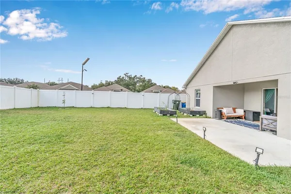 a view of a backyard with table and chairs