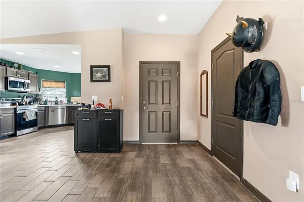 a kitchen with stainless steel appliances granite countertop a refrigerator and a stove top oven